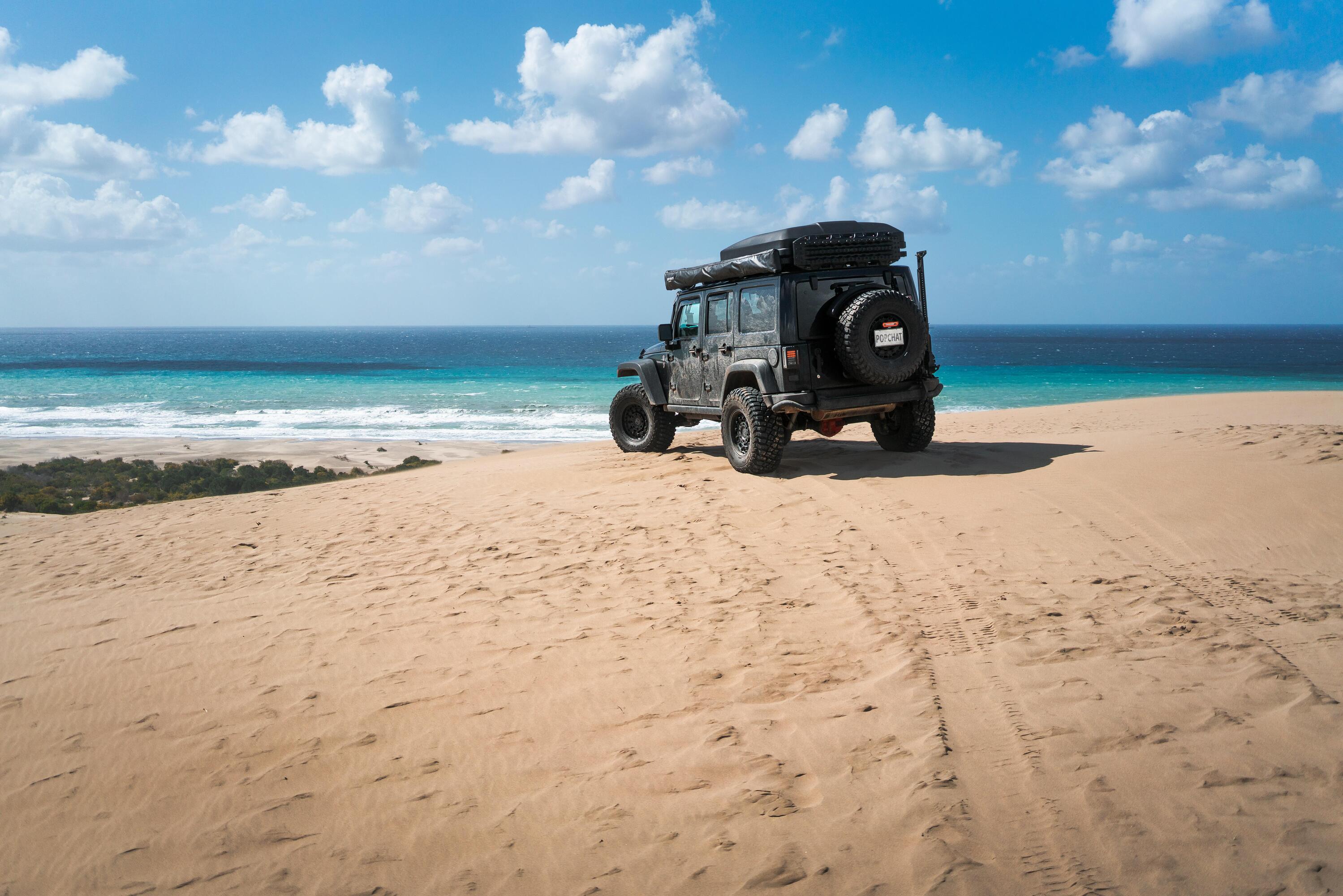 Jeep on a beach with a Popchat license plate